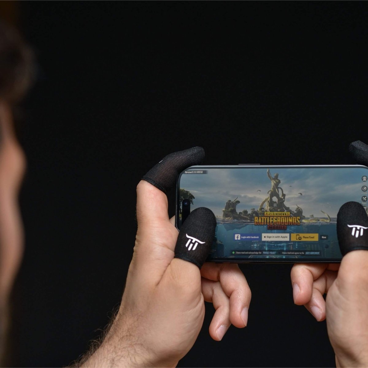 Person playing a mobile game on a smartphone with MinoanSocks