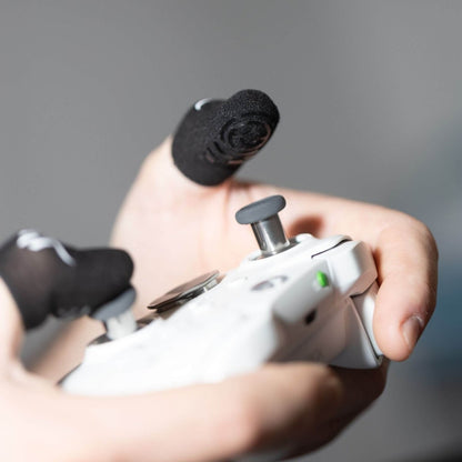 Close-up of GripSticks Carbon finger sleeves on PlayStation controller analog sticks