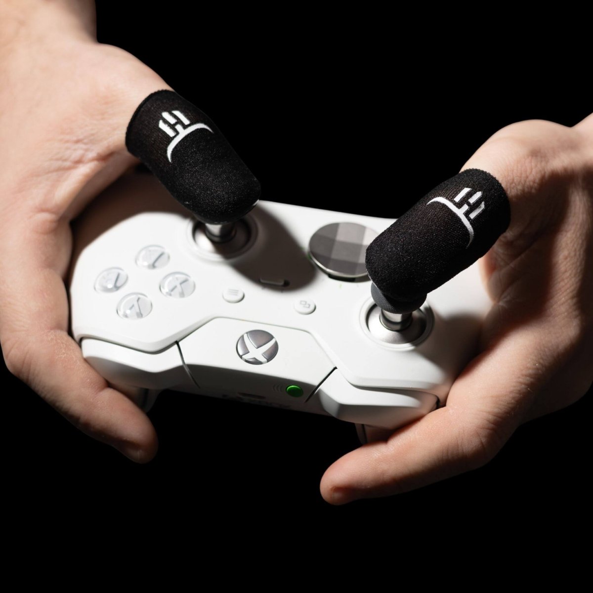 Gamer wearing GripSticks Carbon finger sleeves while playing with console controller