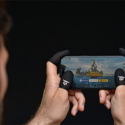 Person playing a mobile game on a smartphone with MinoanSocks 