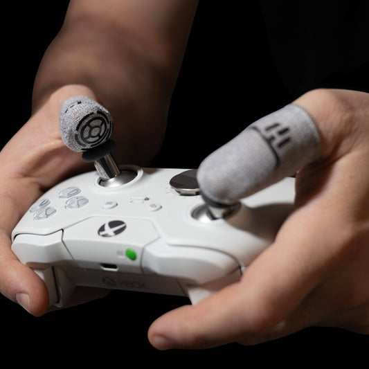 MinoanSocks Close-up of hands holding a gaming controller with a dark background